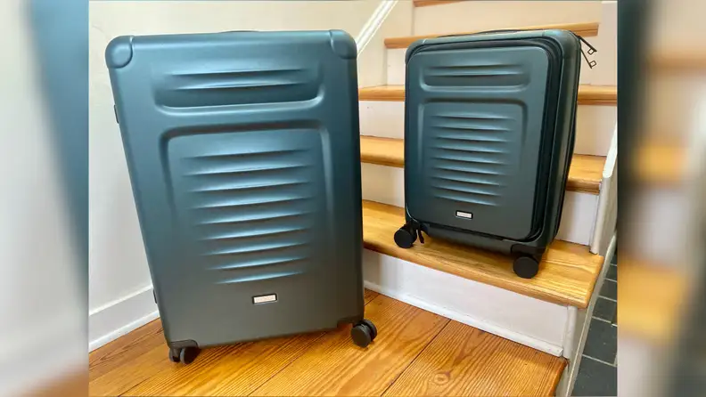 The Coolife Luggage Set Checked Suitcases sitting on wooden stairs.