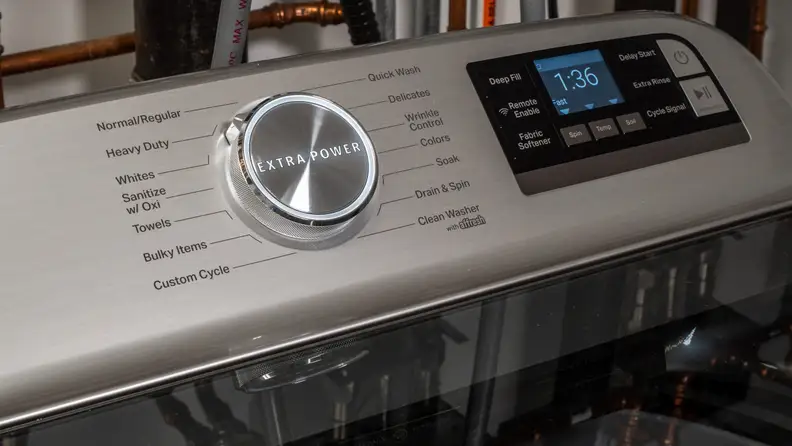 The Maytag MVW8230HC top-load washer's control panel, which consists of a large cycle selection dial and a touchpad for cycle customization options.