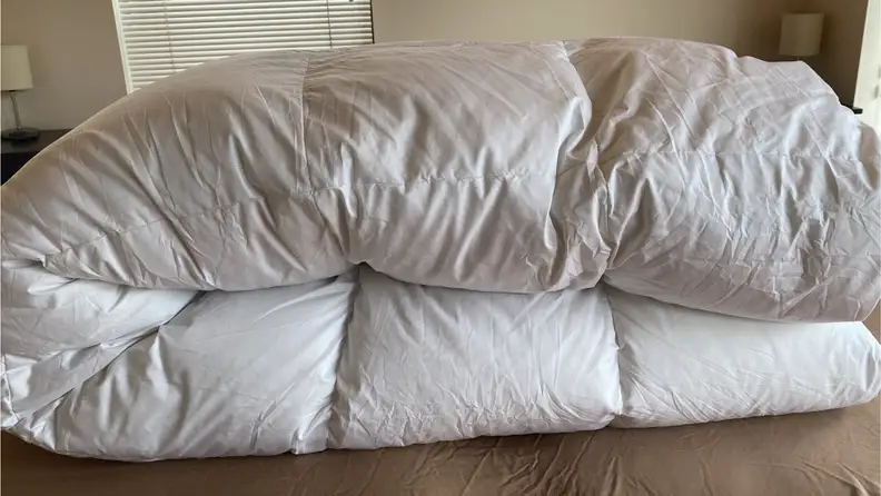 White Pacific Coast Feather & Down Comforter shown folded in half.