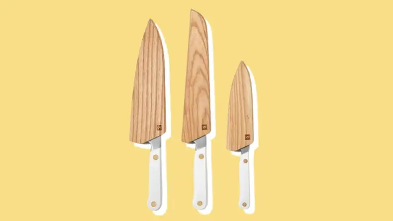 Wooden sheaths on top of Hedley & Bennett knives of different sizes.