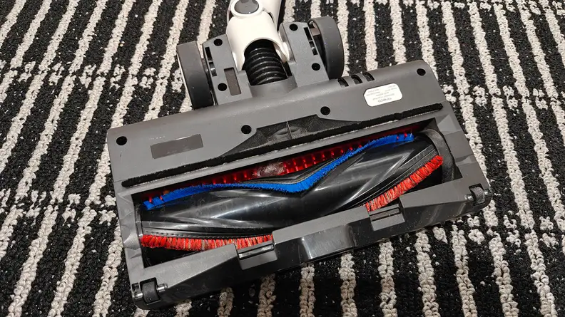 A vacuum head upside down with full view of the roller brush