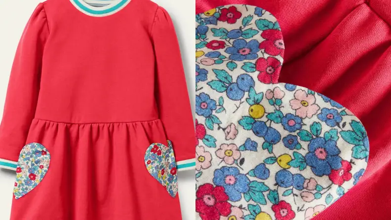 Red children's dress with floral hearts pockets on fronts.