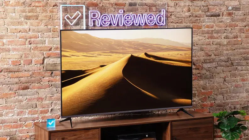 The Roku Plus Series QLED TV with sand dunes onscreen.