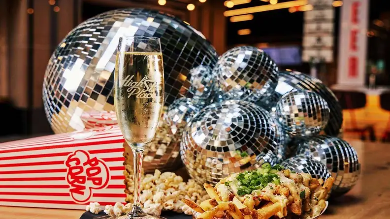 Champagne, popcorn, and fries beside disco balls at High Street Place
