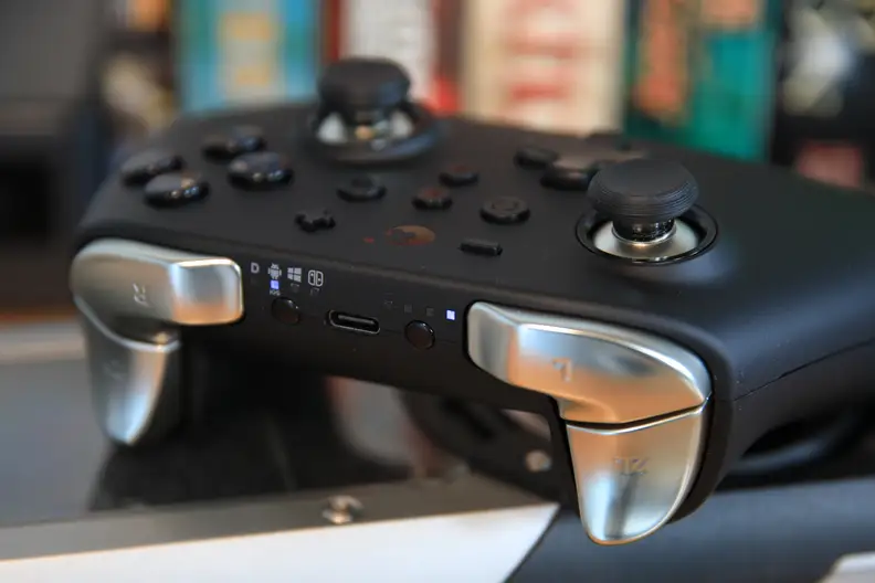 The Gulikit KingKong 2 Pro Wireless controller features silver buttons and joysticks.
