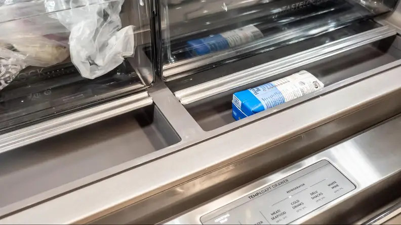 Extra bottom bin opened with a packet of coconut water inside.