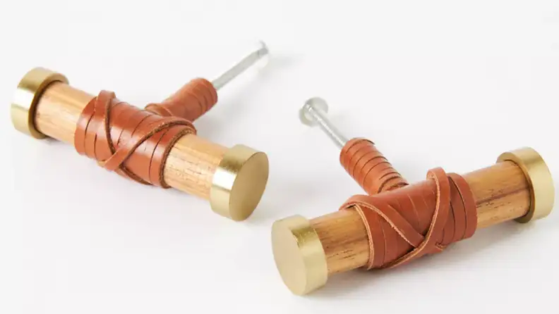 Two teakwood cabinet handles side by side