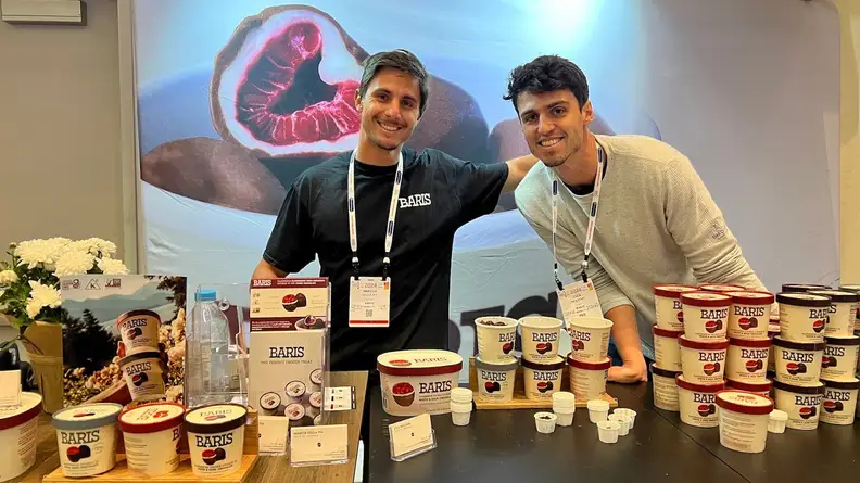 Two people standing in front of Baris Expo West display