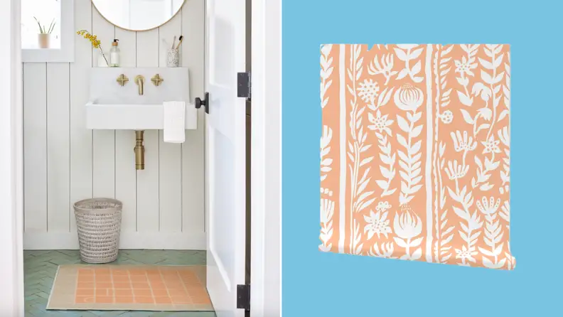 Peach and tan colored area rug with grid pattern on front on bathroom floor next to roll of wallpaper.