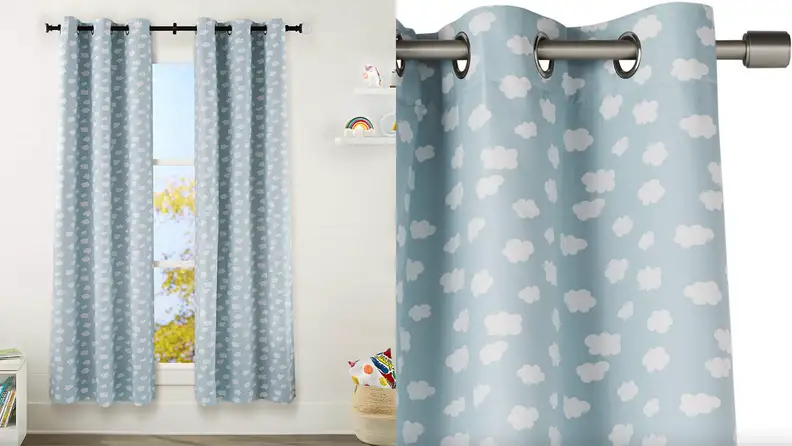 Pastel blue children's curtains in bedroom covered in white clouds.