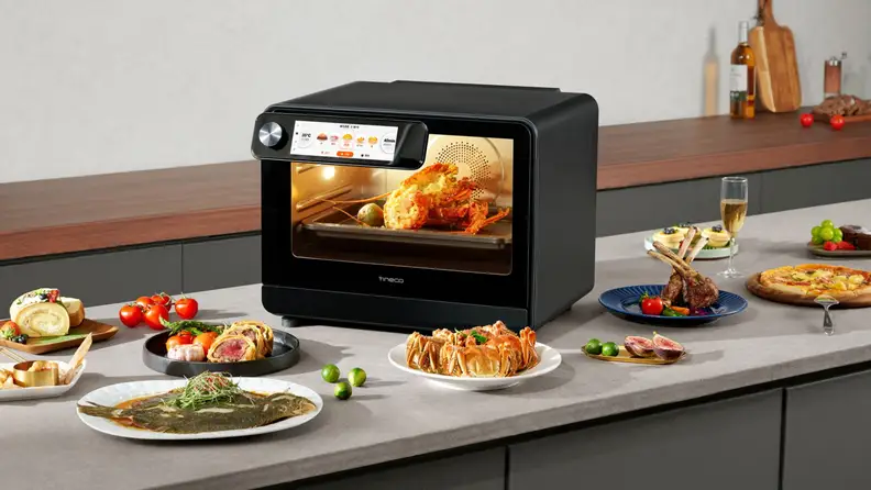 Tineco smart oven on kitchen counter surrounded by cooked food
