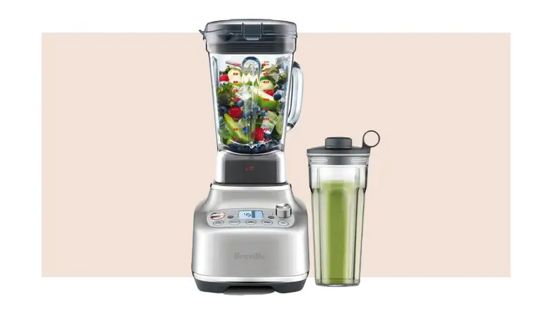 Breville Super Q blender and attachments on beige background