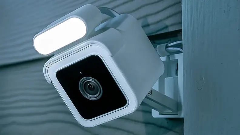 An outdoor security camera with a light attachment.