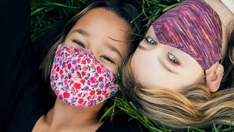 Two girls in floral masks
