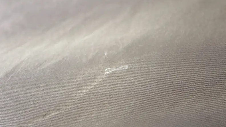 Close up of the duvet showing a thread coming out.