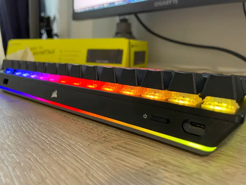 An angled view of a black keyboard highlighting its RGB lighting.