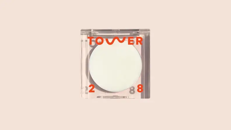 The Highlighter Balm in front of a background.
