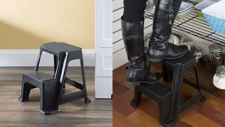 A person steps up on a step stool.