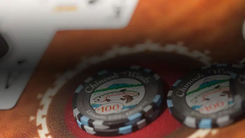 Poker chips and an ace of spade card on a poker table
