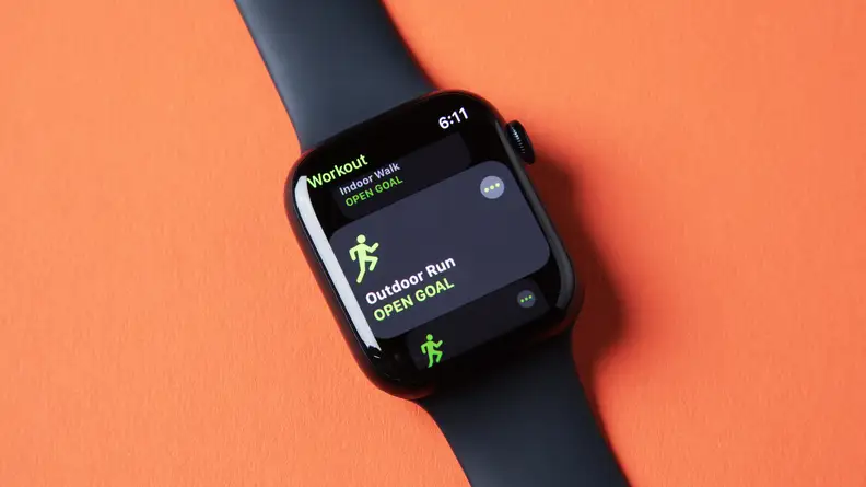 An Apple Watch Series 8 sits against an orange background