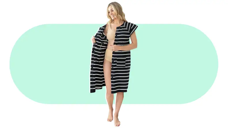 A person modeling an open Gownies Adaptive Hospital Gown.