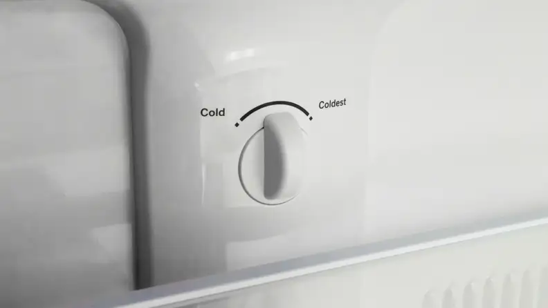 Temperature adjustment knobs inside a GE refrigerator