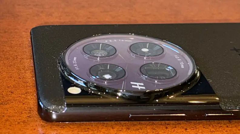 The back of a black OnePlus 12 smartphone showing it's camera array.