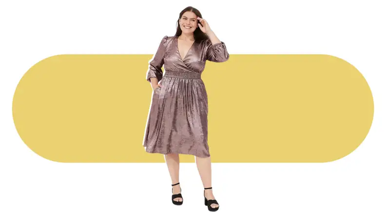 A model wearing a metallic pink knee-length dress with long sleeves.