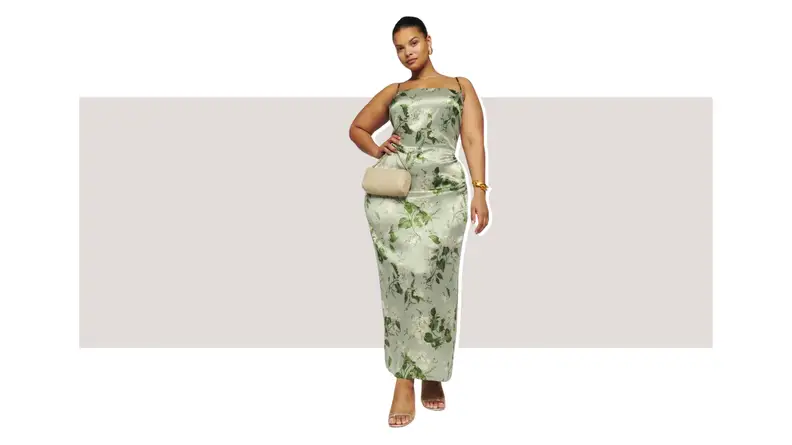 A model wearing a green floral print silk maxi dress.