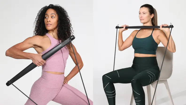 Two women using the Bodygym for single-arm rows and shoulder presses.