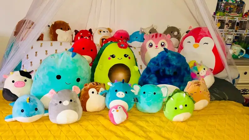 squishmallows sitting atop a yellow bed spread