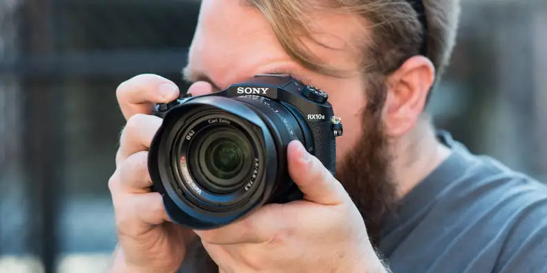 Photo of a photographer shooting with the RX10 II.