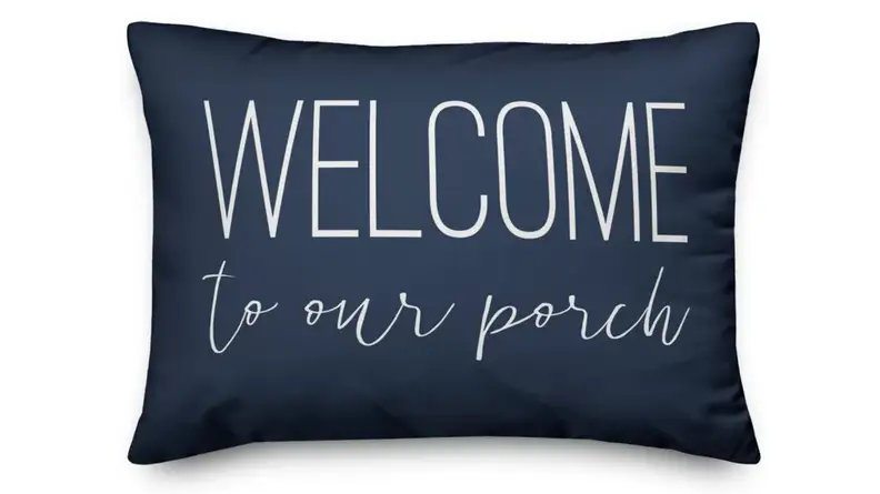 Blue pillow that says Welcome to our porch