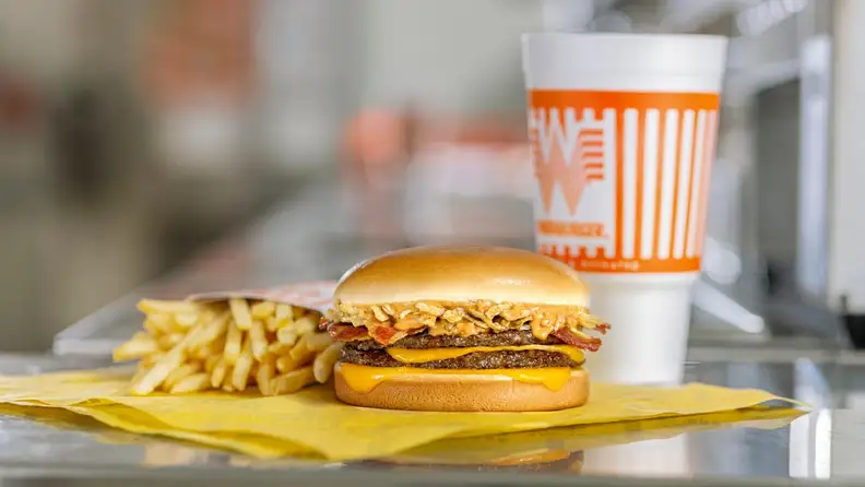 A Whataburger bacon cheeseburger with fries and a drink