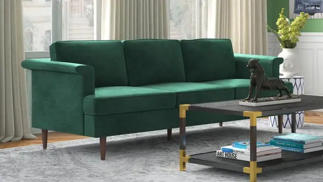 Green velvet couch in living room.