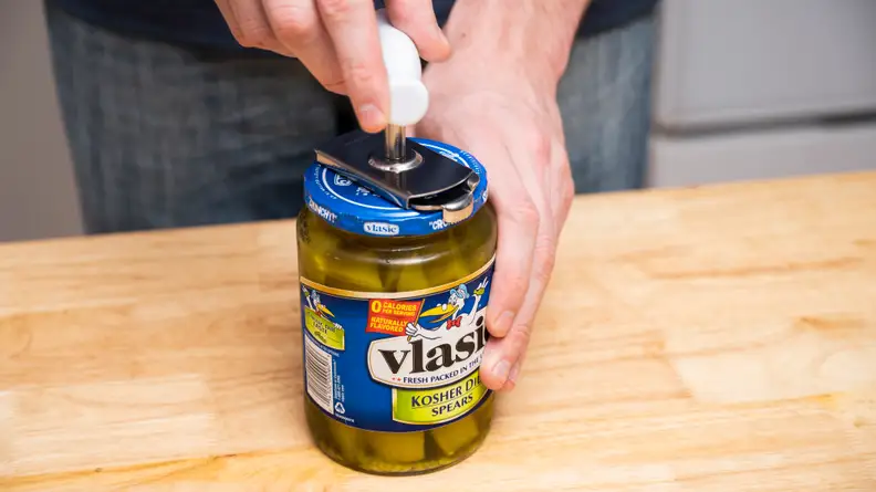 Close-up of a tester opening a jar of Vlasic pickle spears.
