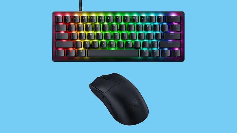 Razer PC Esports Gaming Bundle shown with rainbow backlit keys and included mouse against a light blue background.