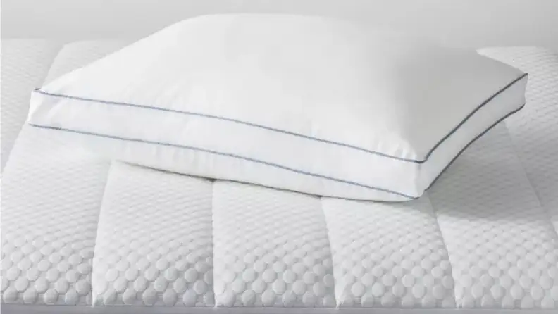 a gusseted pillow sits on a mattress pad