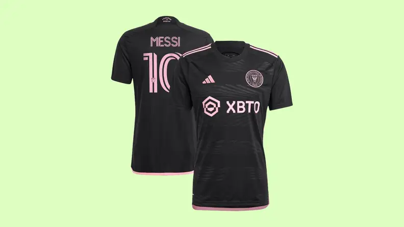 A black Inter Miami Lionel Messi jersey on a light green background.