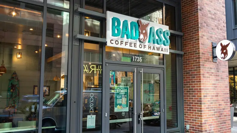 Storefront of Bad Ass Coffee of Hawaii with a donkey logo sign