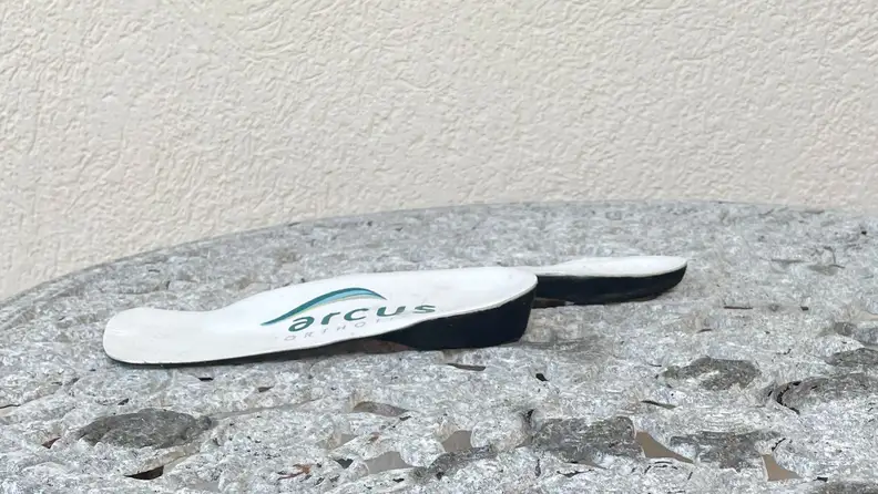 Two insoles with the Arcus logo