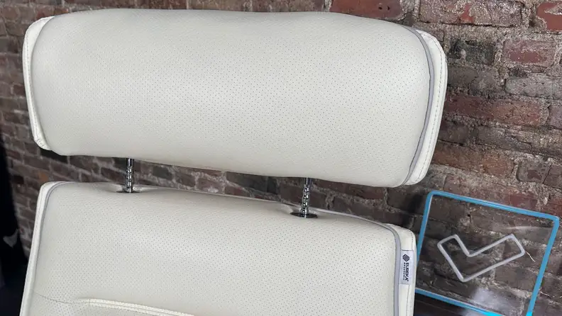 A close-up of the adjustable headrest, extended upwards on the Eureka Royal executive office chair.