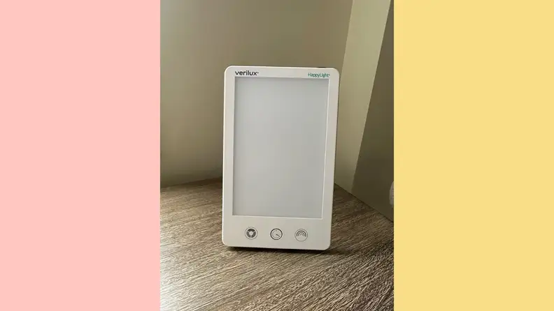 The Verilux HappyLight Luxe sitting on a table