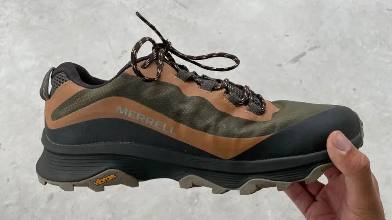hand holding Merrell Moab Speed shoe