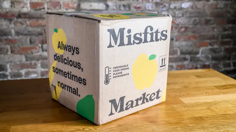 A Misfits Market box sits on a wood countertop.