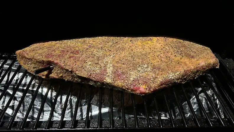 A piece of brisket with a Meater attached.