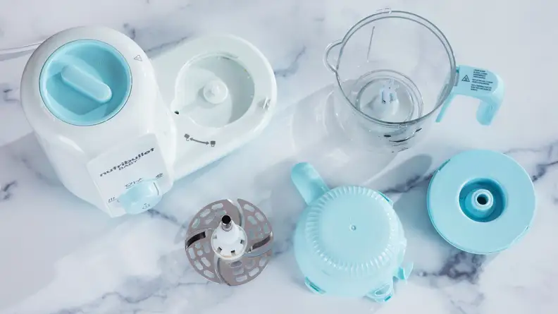 The Nutribullet Baby Steam + Blend parts spread out side-by-side on a counter.