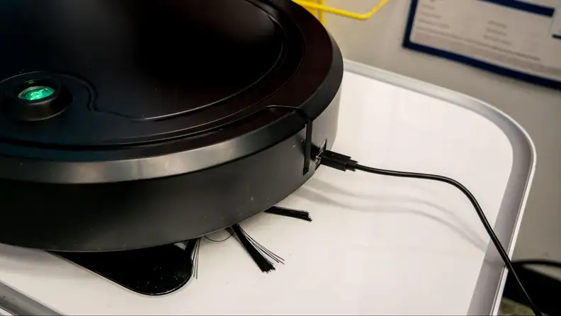 The Digital Essentials Robotic Vacuum Cleaner charging via USB.