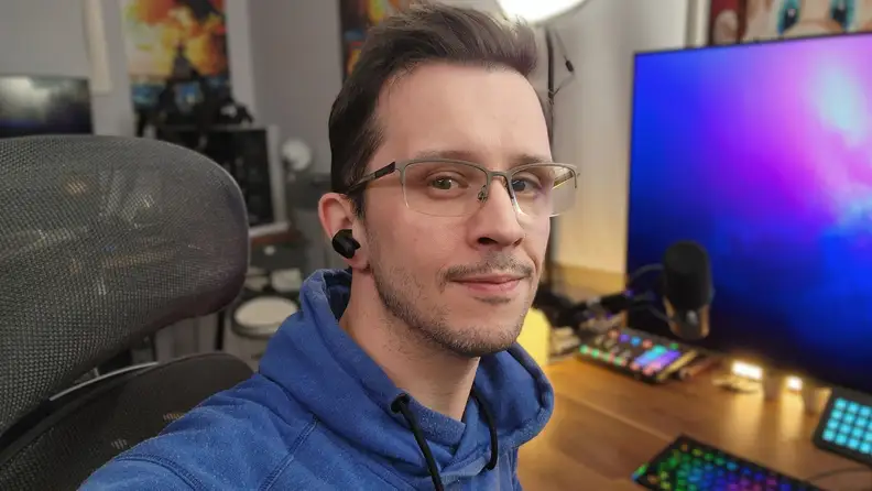 A man taking a selfie wearing the Sony Inzone Buds.
