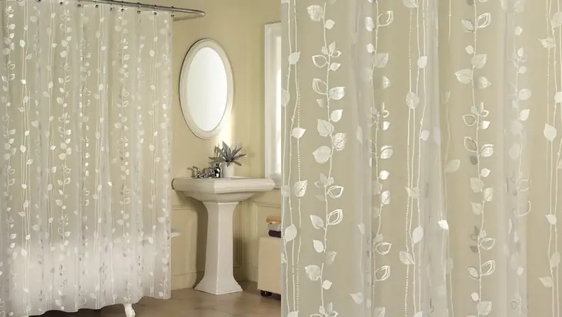 A shower curtain with a gold ivy print.